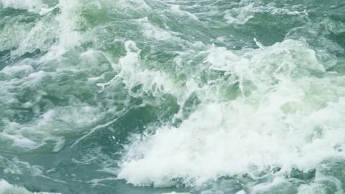 Rushing River Water Forms Waves and Foam
