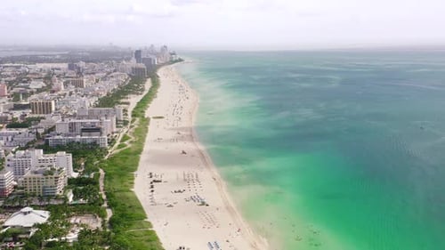 View of the Coastal Part of the City with Houses and roads.The Beach Extends To the Horizon