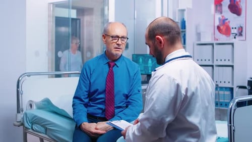 Doctor Consults with Patient in Hospital Room