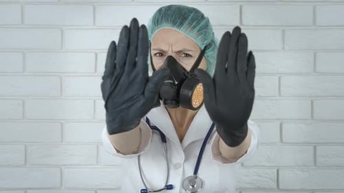 Woman Doctor Wearing Respirator Gesturing Stop