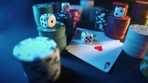 Casino Chips with Dice and Playing Cards on a Dark Table