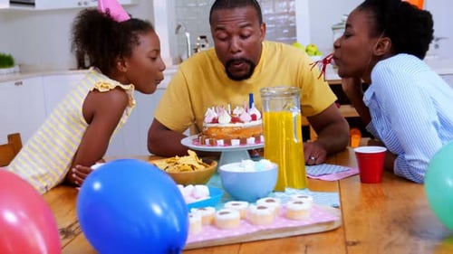 Family Celebrates Birthday at Home with Cake