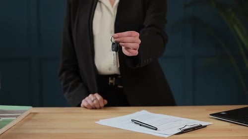 Woman Holding Keys in Office Environment