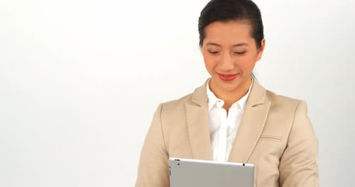 Smiling Woman Uses Tablet on White Background