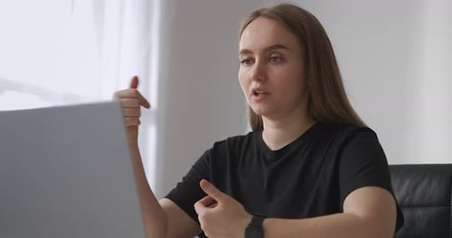 Young Woman Talking During an Online Meeting