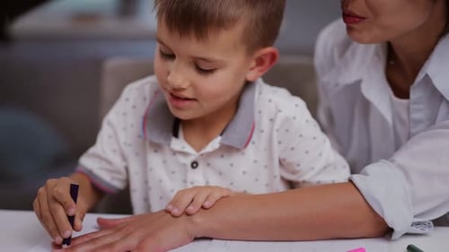 Boy Drawing with Mother