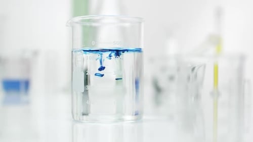 Blue Dye Mixing in Clear Liquid in Beaker