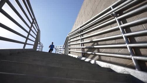 Man Runs Down Urban Concrete Staircase