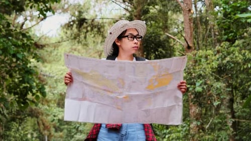 Happy young tourist woman with backpacks in a tropical forest.