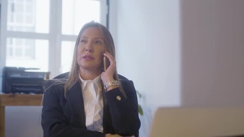Professional Woman Talking on Phone in Office Setting