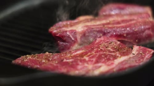Sizzling Meat Cooking on Grill Pan