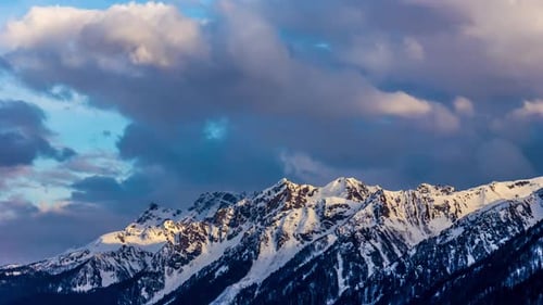 Snowy Mountains Peaks at Sunrise or Sunset