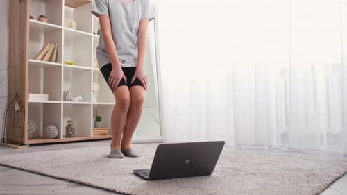 Woman Exercising in Front of Computer at Home