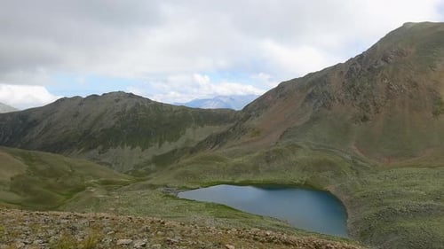 Timelapse scenes in mountains with lake and moving clouds in national park of Dombay