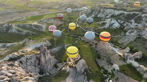 4K Aerial view of Goreme. Colorful hot air balloons fly over the valleys.