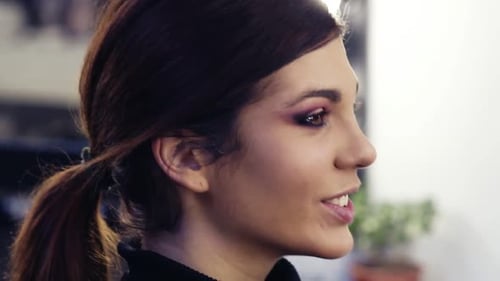 Footage of Unrecognizable Hand Applying Dark Pigmented Eyeshadows on the Lower Lid of Beautiful