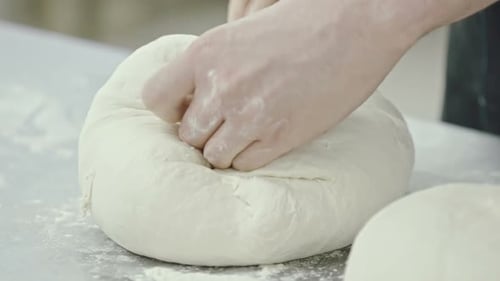 Hands Kneading Fresh Dough Ball for Baking