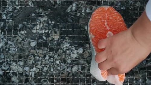 Salmon Steak Grilling on Charcoal Grill. Closeup Grilling Salmon Fillet on Grill