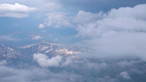 Snow Mountains Partially Shrouded by Clouds from Above