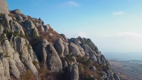 Aerial View of a Drone Flying Through Sharp Rocky Outcrops at Sunset