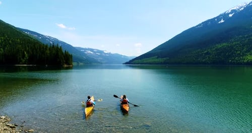 People kayaking in lake 4k
