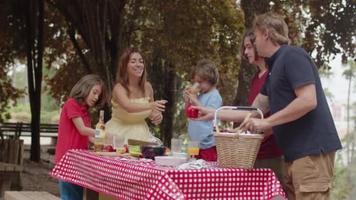 Happy Family Having Picnic in Woods