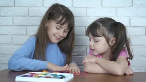 Two Girls Playing with Colorful Modeling Clay
