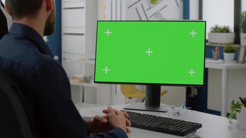 Close Up of Computer with Horizontal Green Screen on Desk