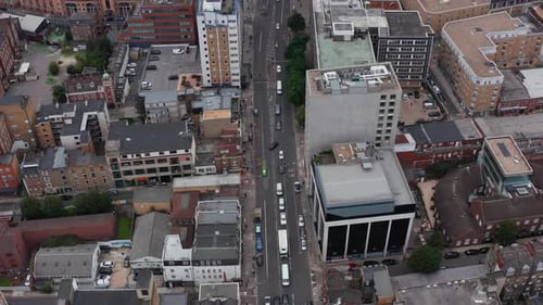 Backwards Fly Above City Streets