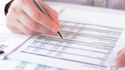 Shot of Businessman Checking the Financial Statement
