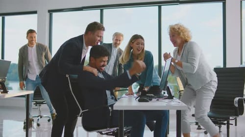 Excited Business Team Celebrating Success in Office