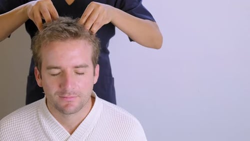 Scalp massage for young man in a spa