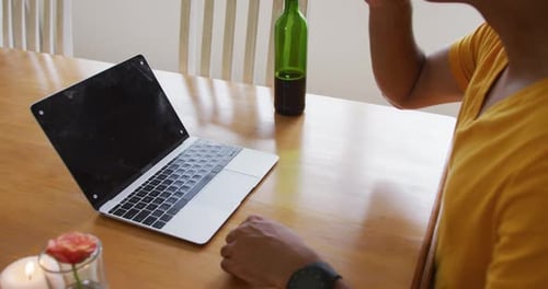 Woman on Video Call With Wine at Table