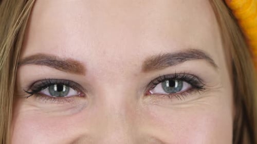 Female Eyes Looking Straight and Smiling. Close Up