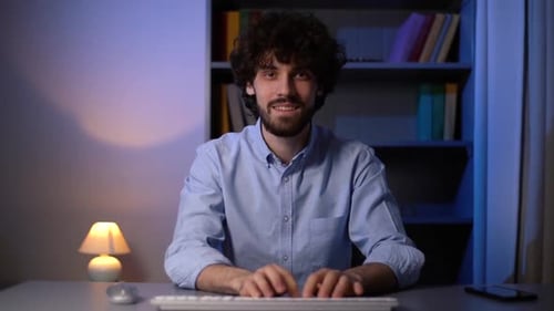 Young Adult Typing at Desk at Night