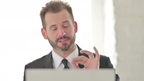 Man Talking on Video Call in Bright Room
