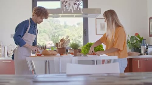 Couple Prepares Food Together in Bright Kitchen