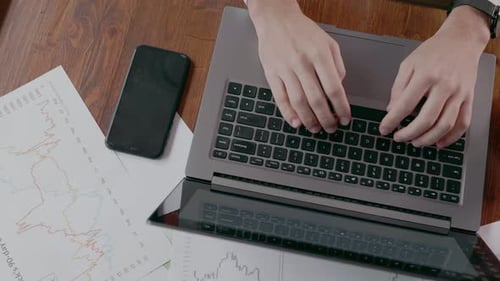 Working at a Laptop in a Cafe Top View