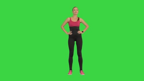 Caucasian Woman Athlete Wearing Black Sportsbra Warming Up Neck Before Workout on a Green Screen