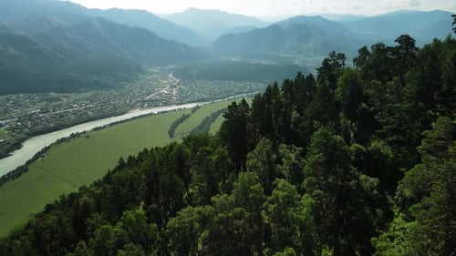 A Large Valley with a Small Village Located in a Hilly Area