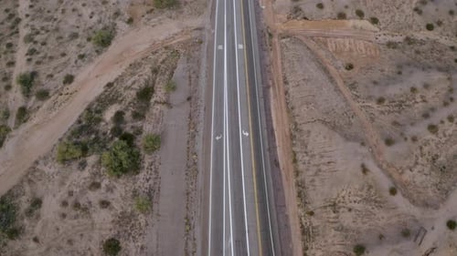 Aerial pull-back over a crossroads in the desert