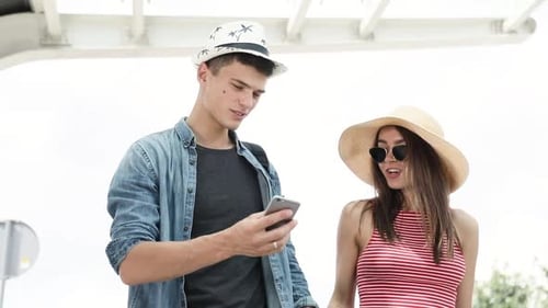 Couple Enjoys Smartphone on Sunny Day Out