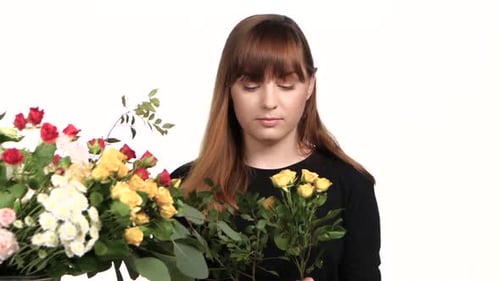 Girl Picking Flowers in a Bouquet. White. Close Up
