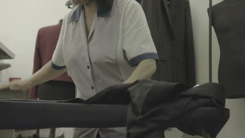 Seamstress ironing pants