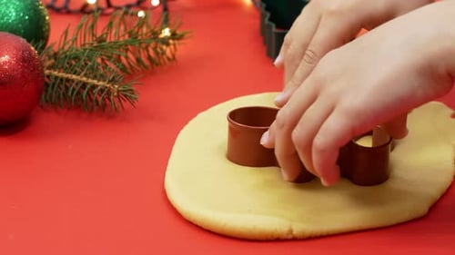 Child Making Christmas Cookies with Cookie Cutter