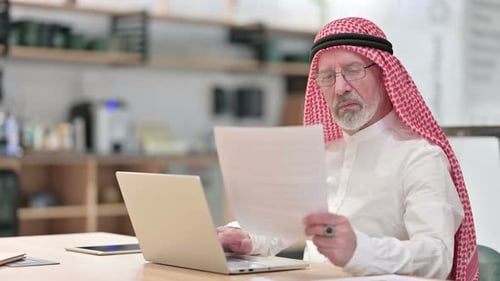Senior Adult Working at Desk with Laptop