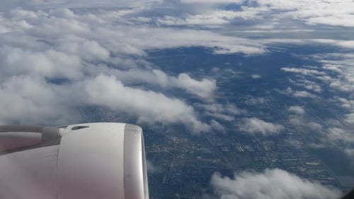 Aerial View from Airplane Window Over Cityscape