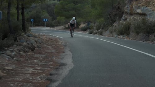 Professional Female Cyclist on Hard Road Training