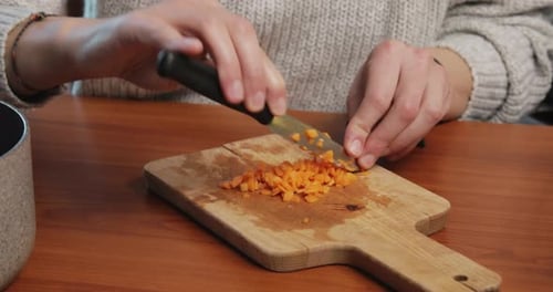 Chopping Diced Carrots on Wooden Cutting Board