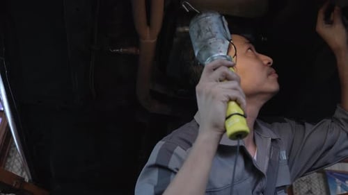 Man checking under car